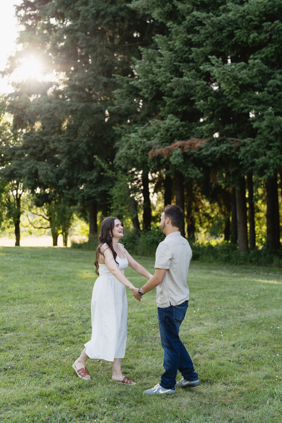 The two hold hands and swing dance on the lawn at Sauvie Island