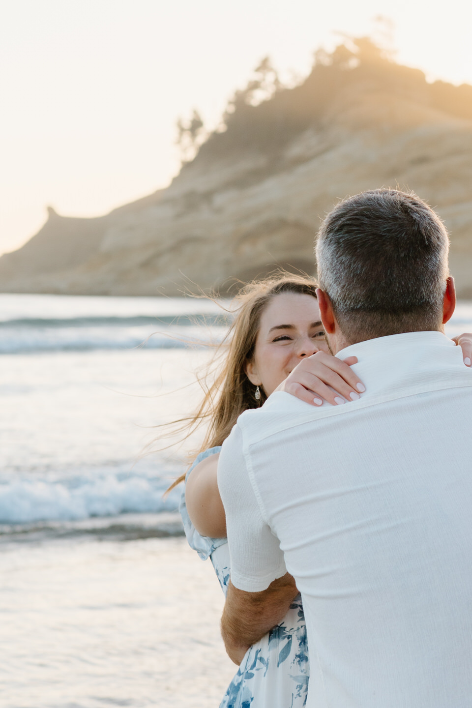 Cape Kiwanda cliff glows in the background of June engagement session.