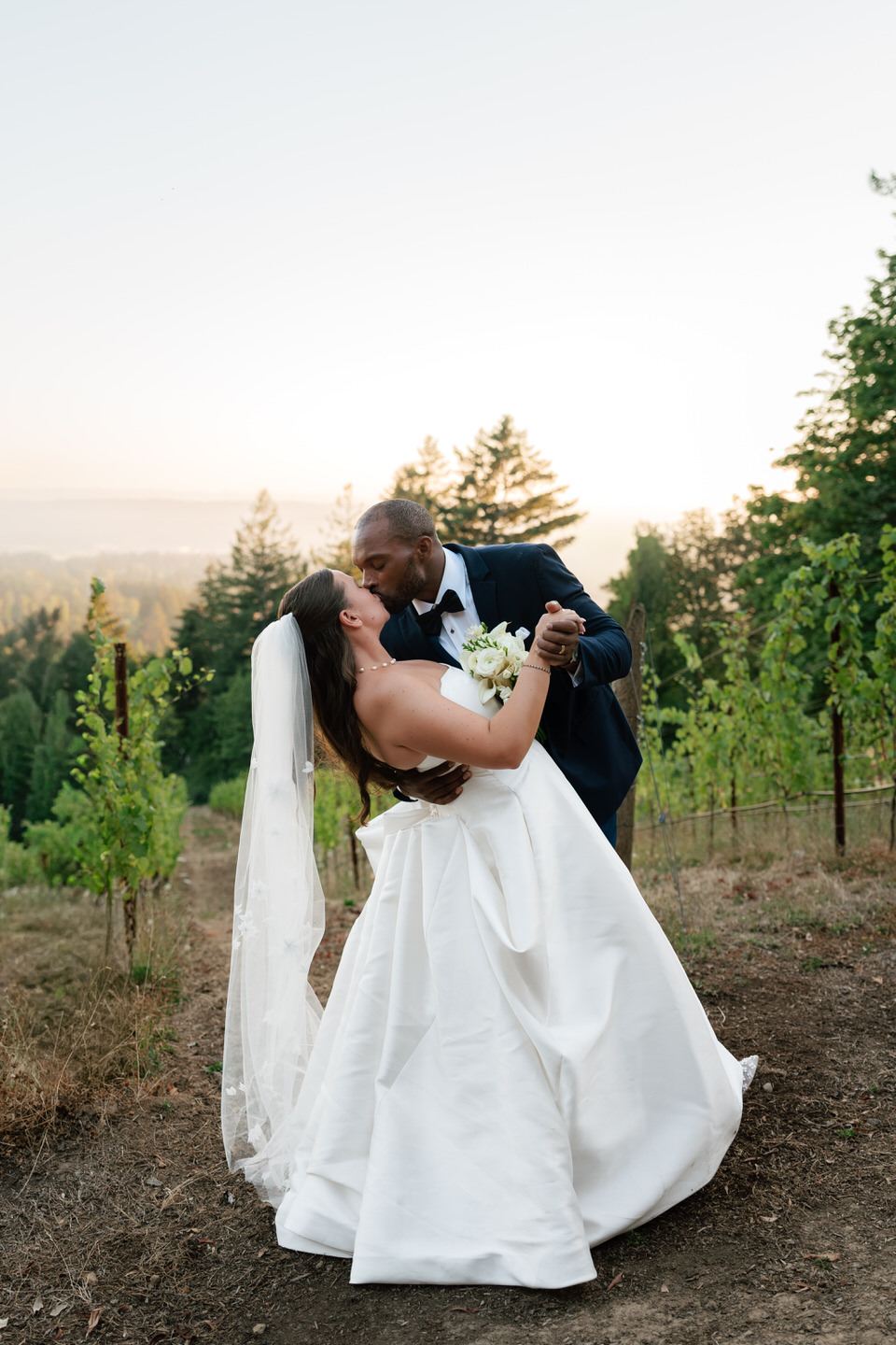 Bride and room golden hour photos in the vineyard at Amaterra in Portland.