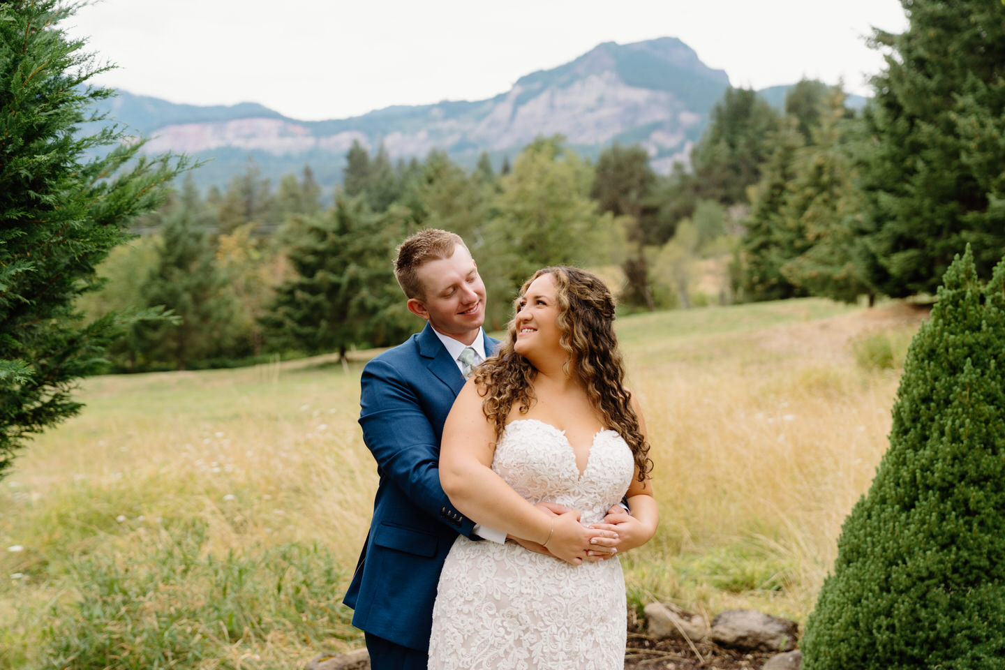 Bride and groom wrap their arms around each other for their Maple Leaf Events wedding in the Columbia Gorge.