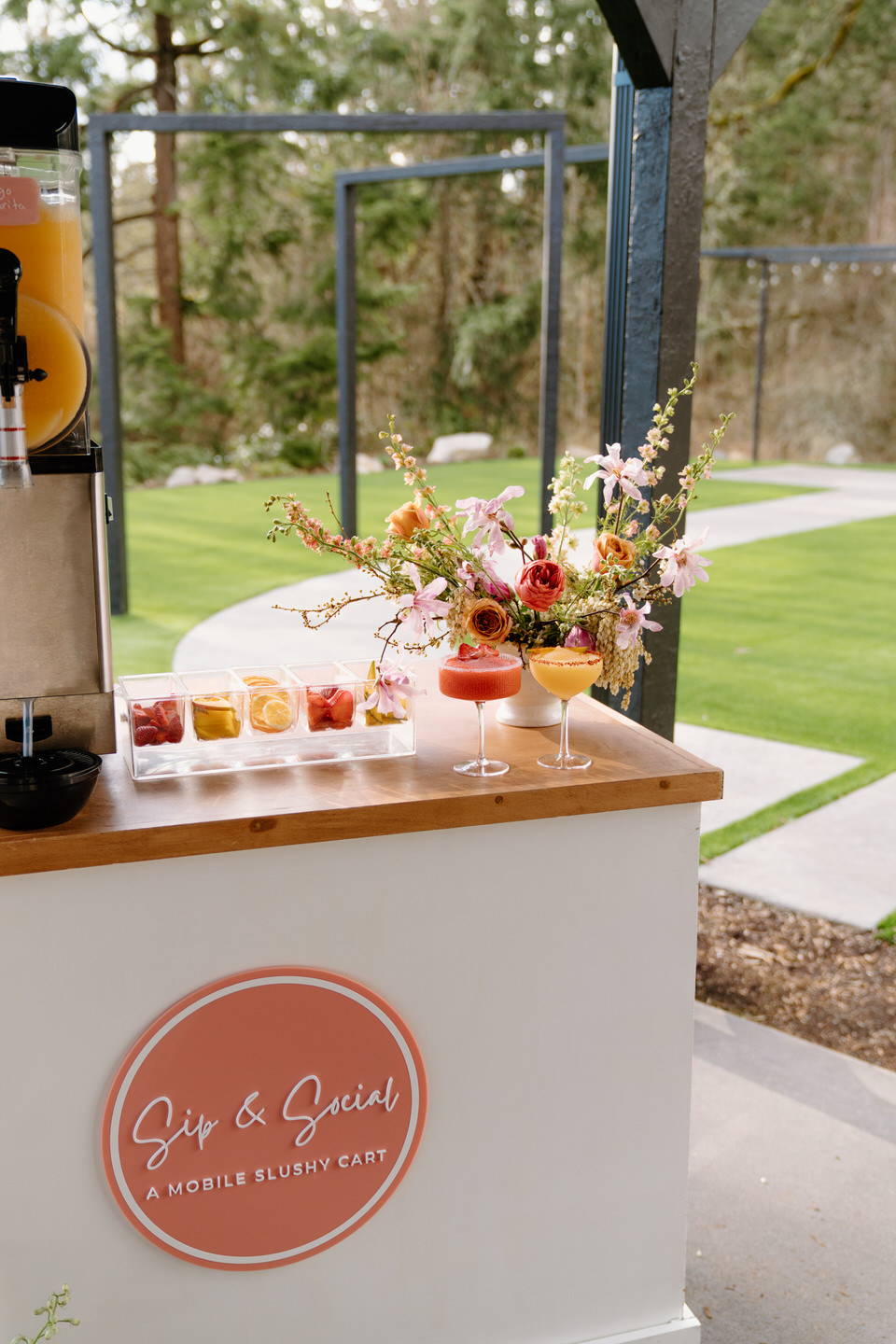 Sip and Social’s mobile slushy cart is styled with pastel signage and sweet spring-inspired treats.