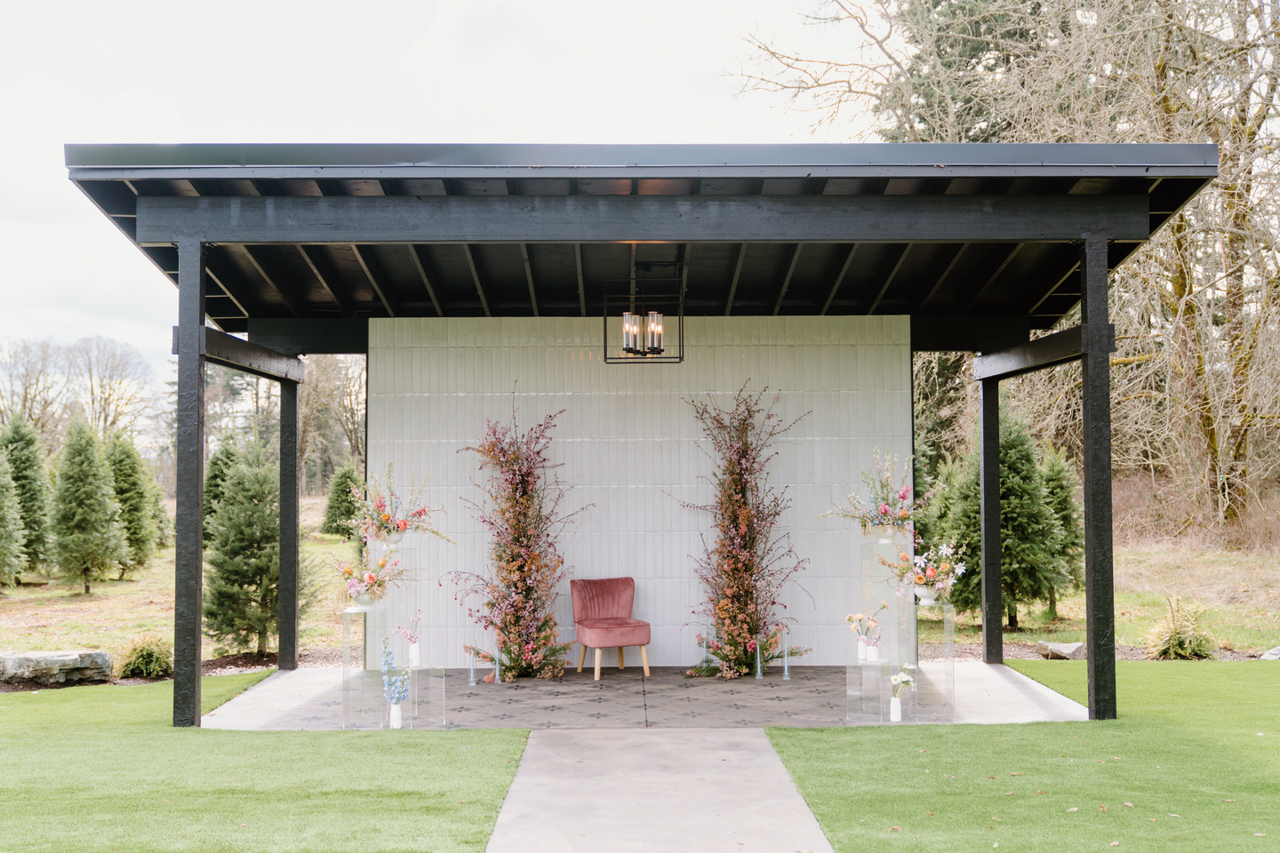 A view of the modern tiled ceremony pavilion at Sage & Social, set for a floral-filled romantic celebration.