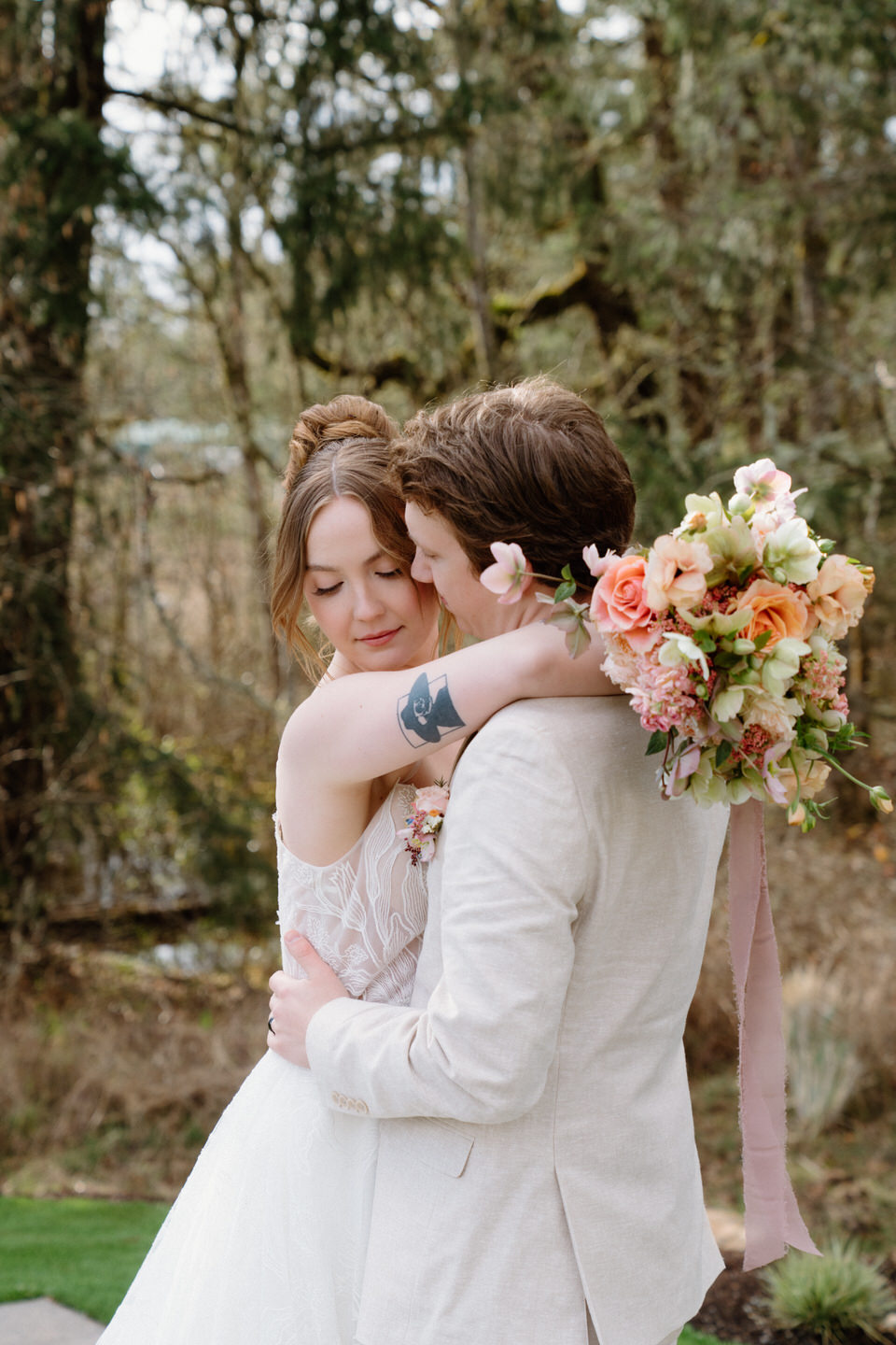A romantic portrait session in the wooded area near Sage & Social, with pastel florals and soft light.