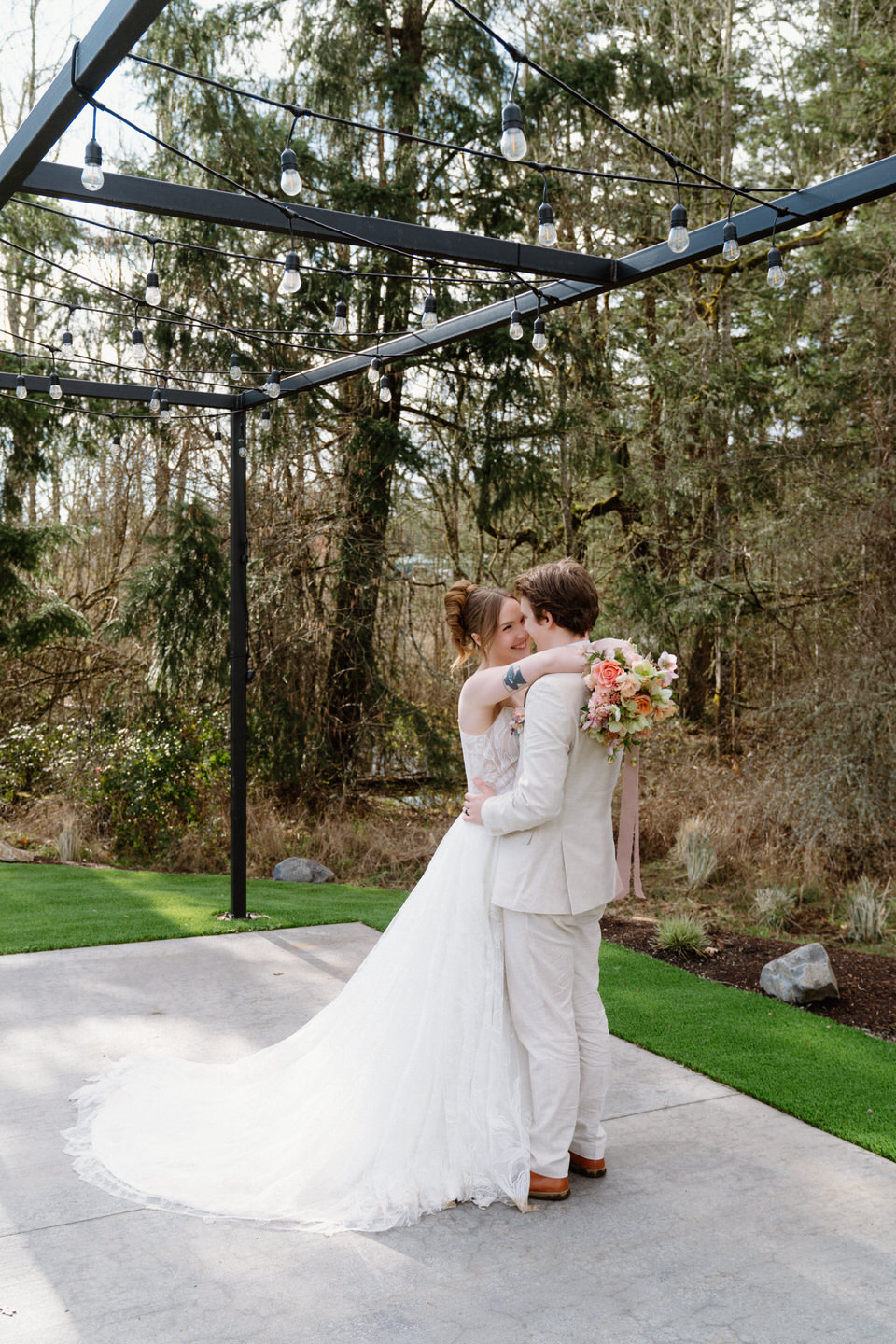 The train of a flowing wedding gown lifts in the breeze during golden hour portraits at Sage & Social.