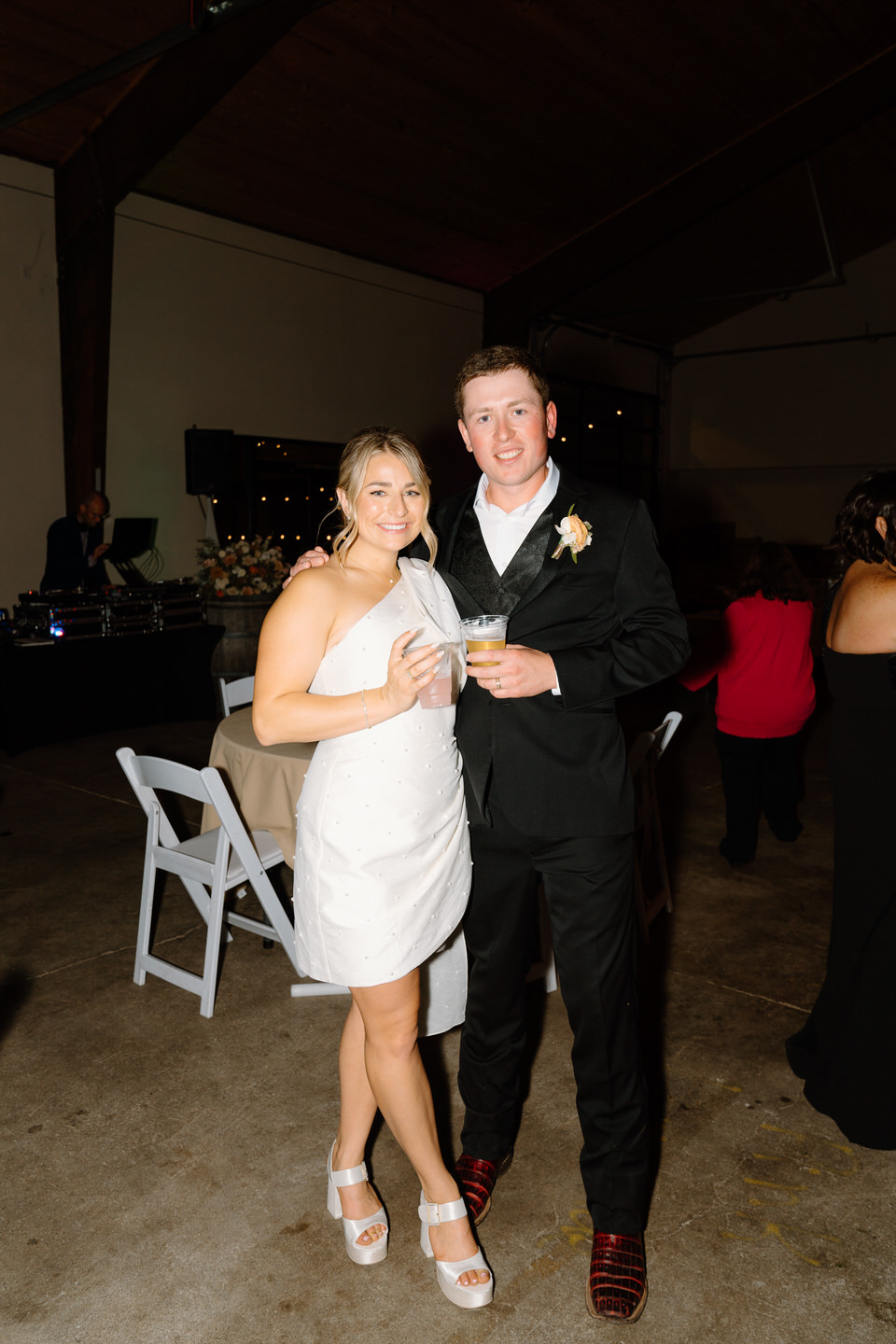 Bride changes into a short party dress for the wedding reception.