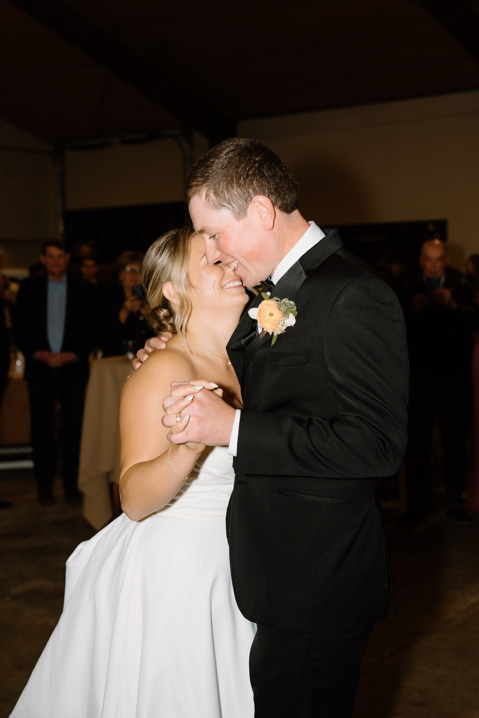 Bride and groom laugh together during their first dance.