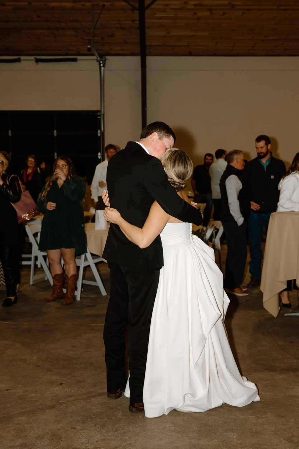Bride and groom share an emotional first dance during wedding reception inside the Barn at Countryside.