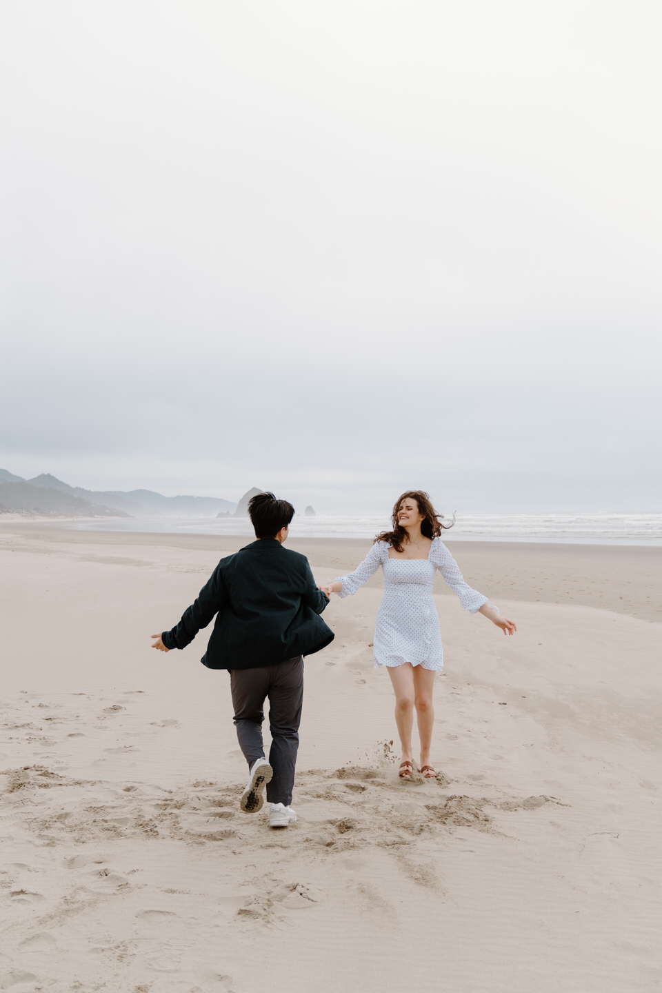 Romantic moment of couple dancing barefoot on the sand.