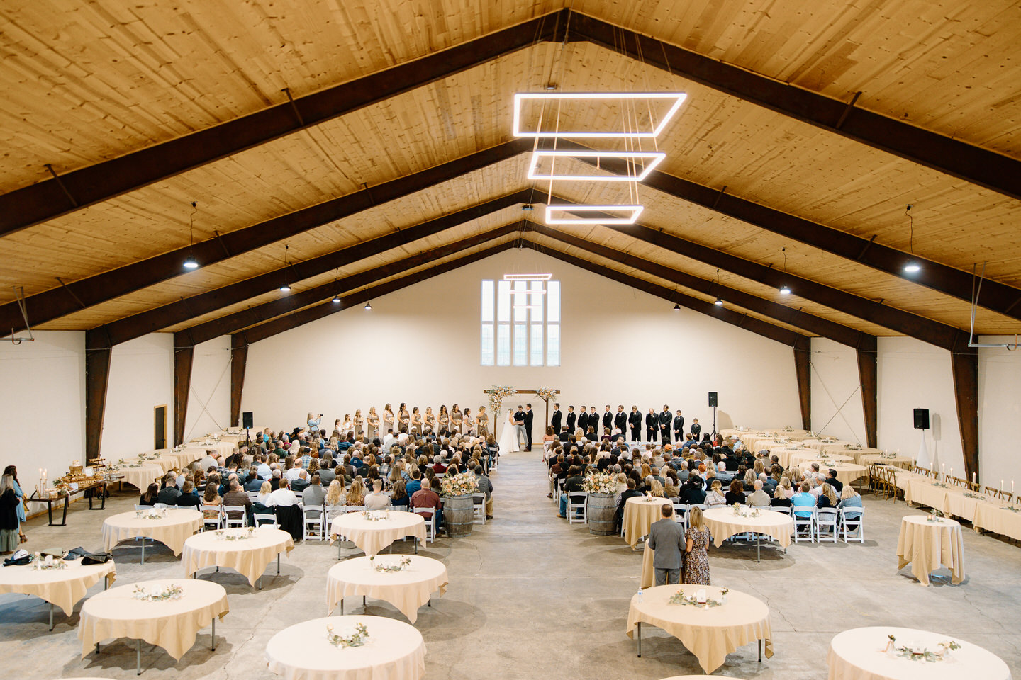 Spacious indoor barn wedding ceremony.