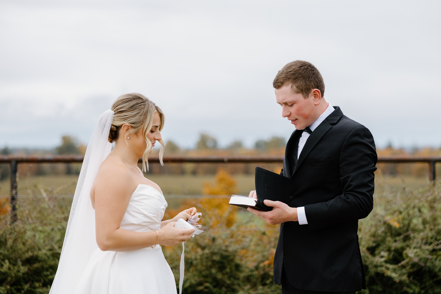 The couple exchanges gifts to each other outside at the Barn at Countryside.