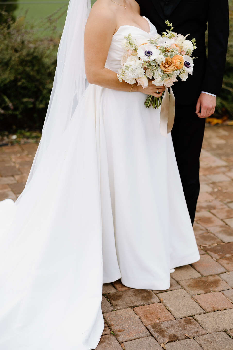 Bride's strapless ballgown and fall floral arrangement.
