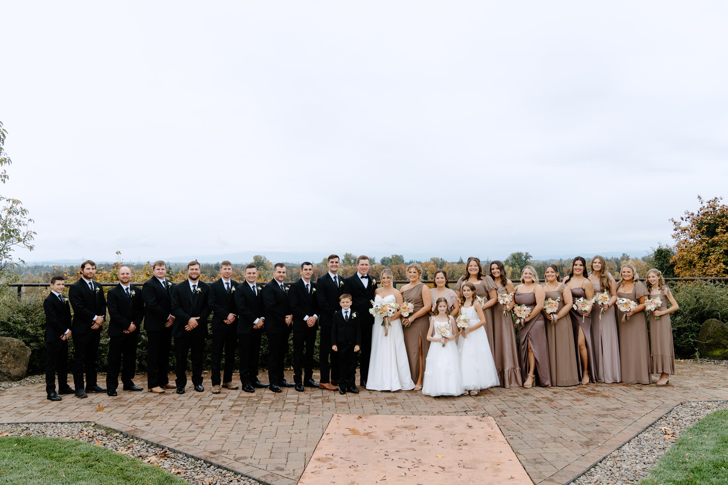 Large wedding party in dark fall colors.