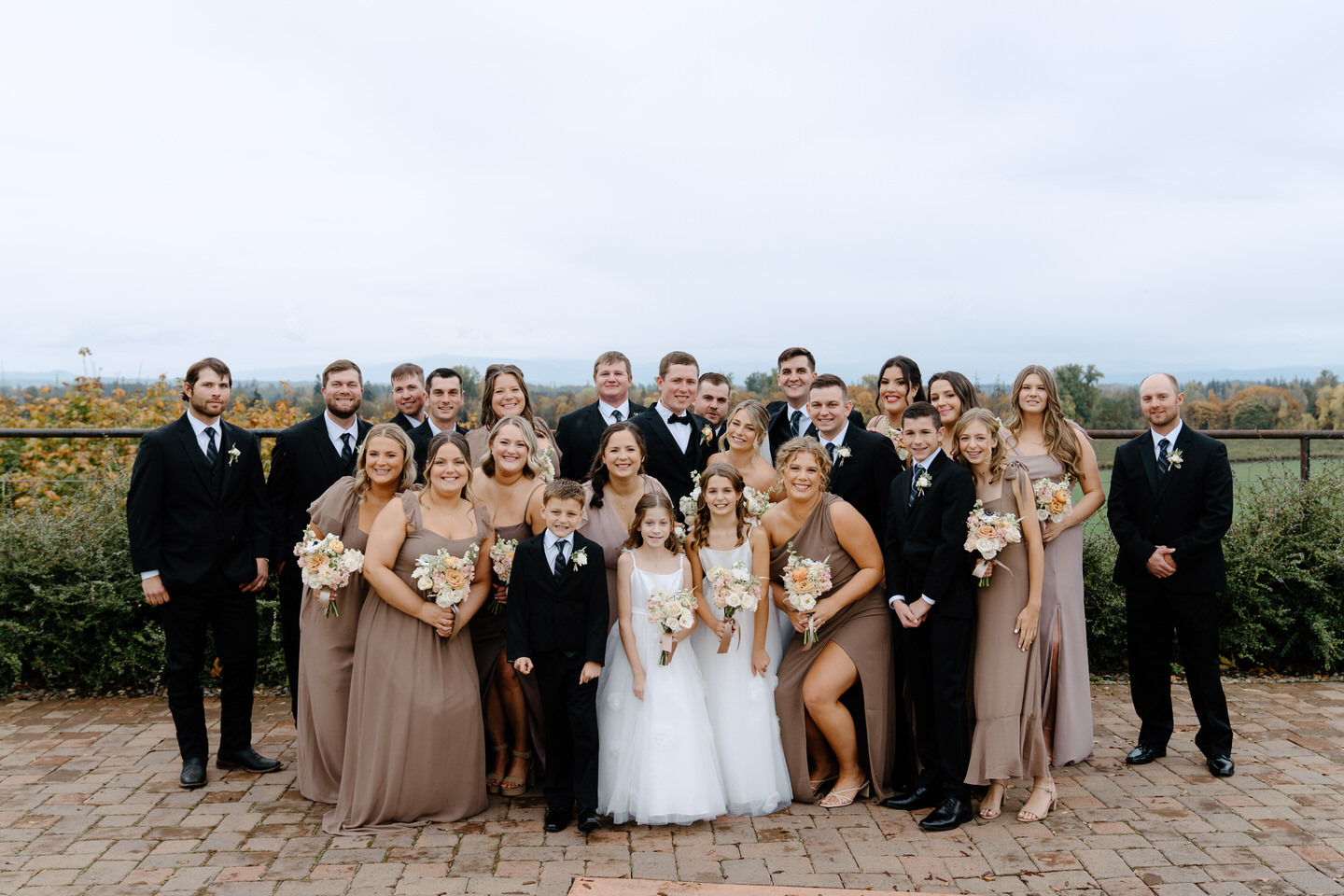 Wedding party gathers together for a photo outside before the rain began.