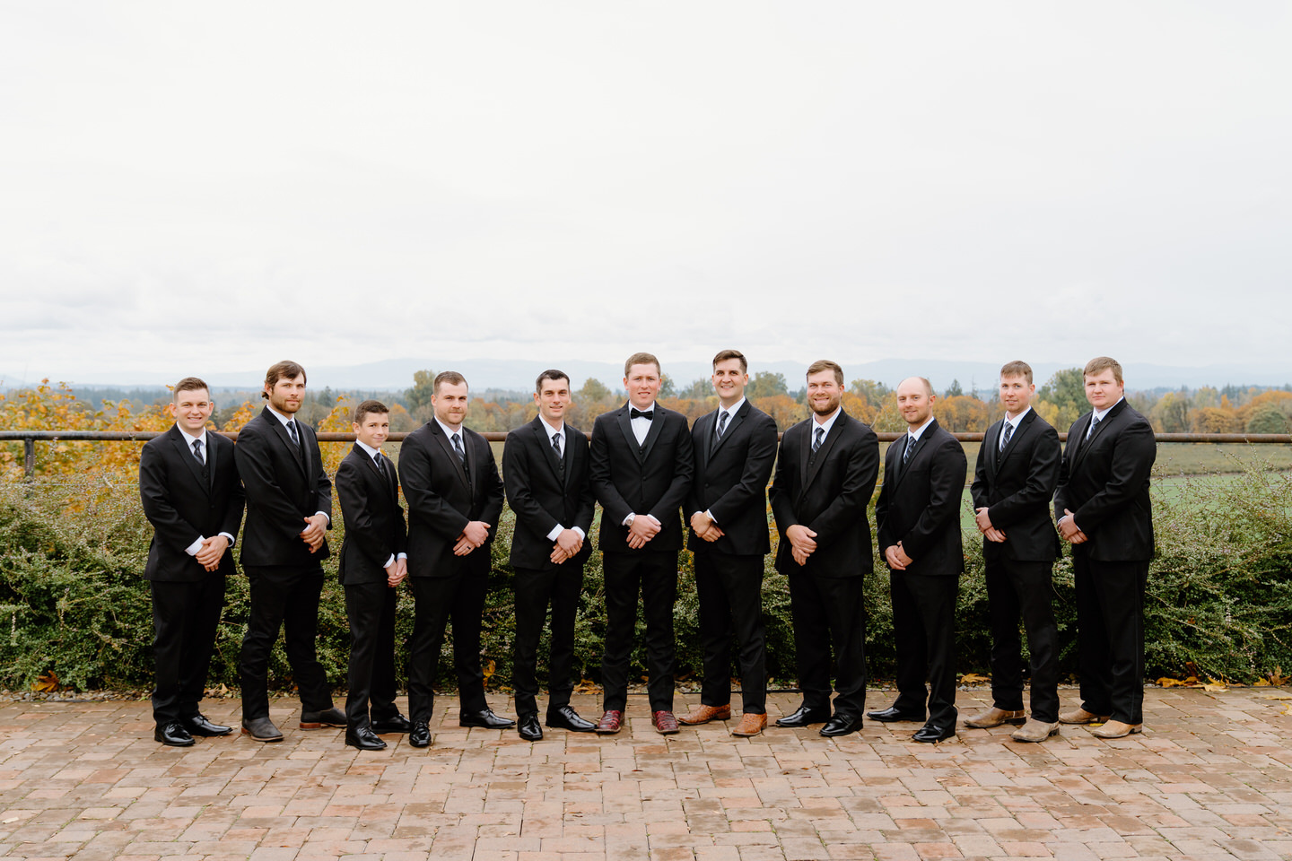 Groom and groomsmen in all black wedding attire.