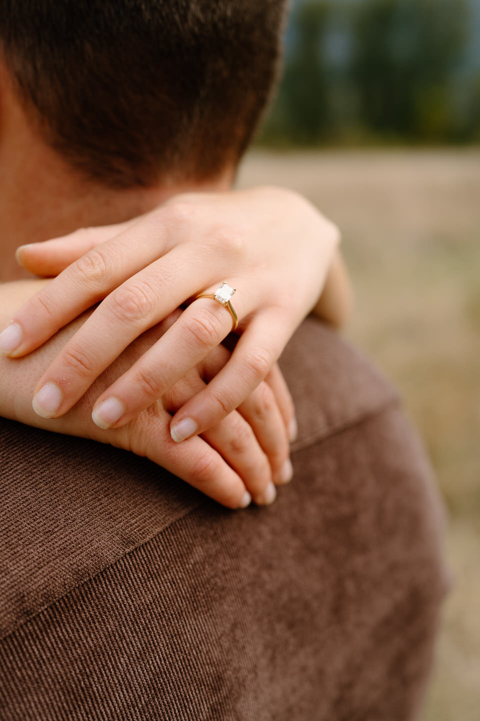 Engagement ring detail shot with natural fall foliage in soft focus — Columbia Gorge autumn engagement.