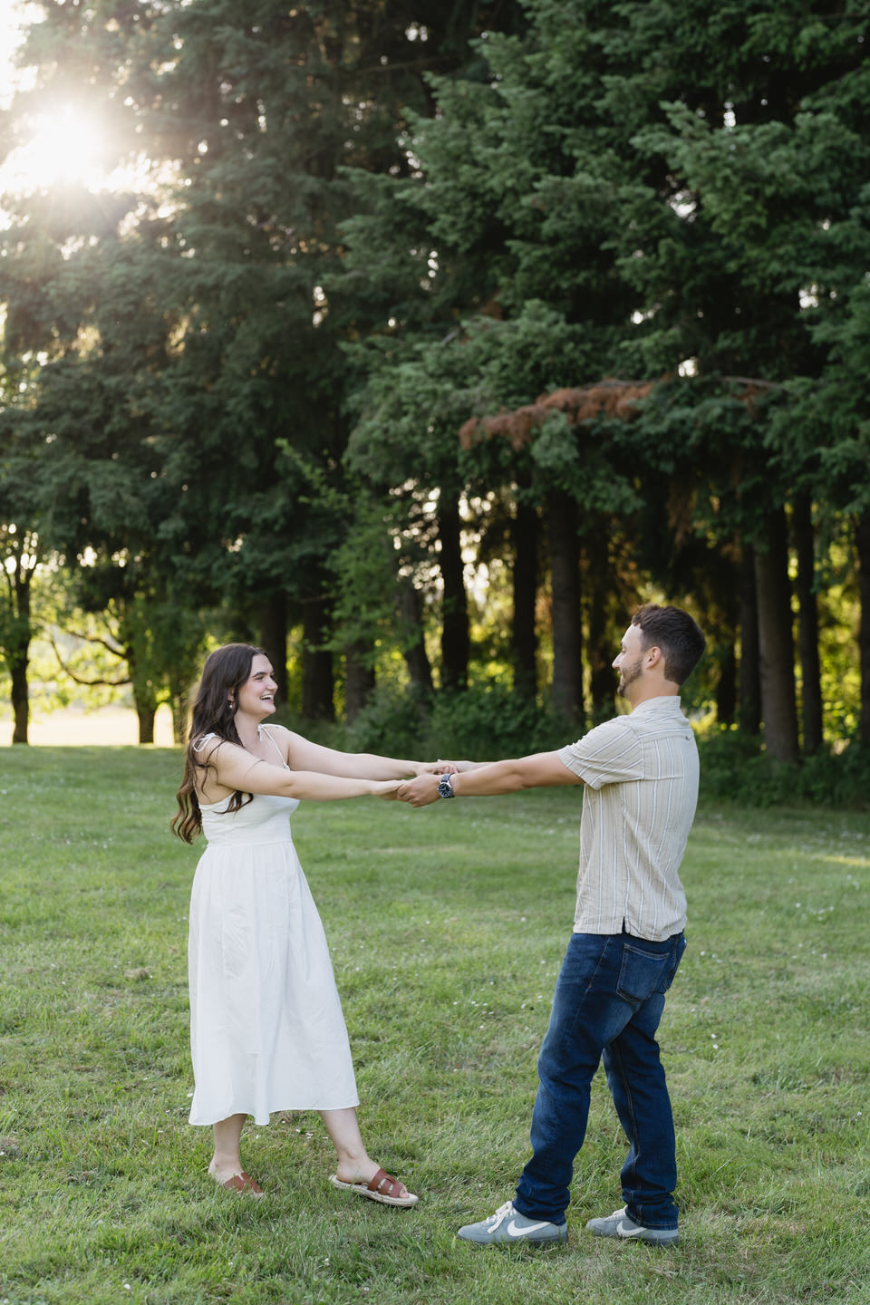Couple dancing in the lawn for summer engagement photos in Portland, Oregon.