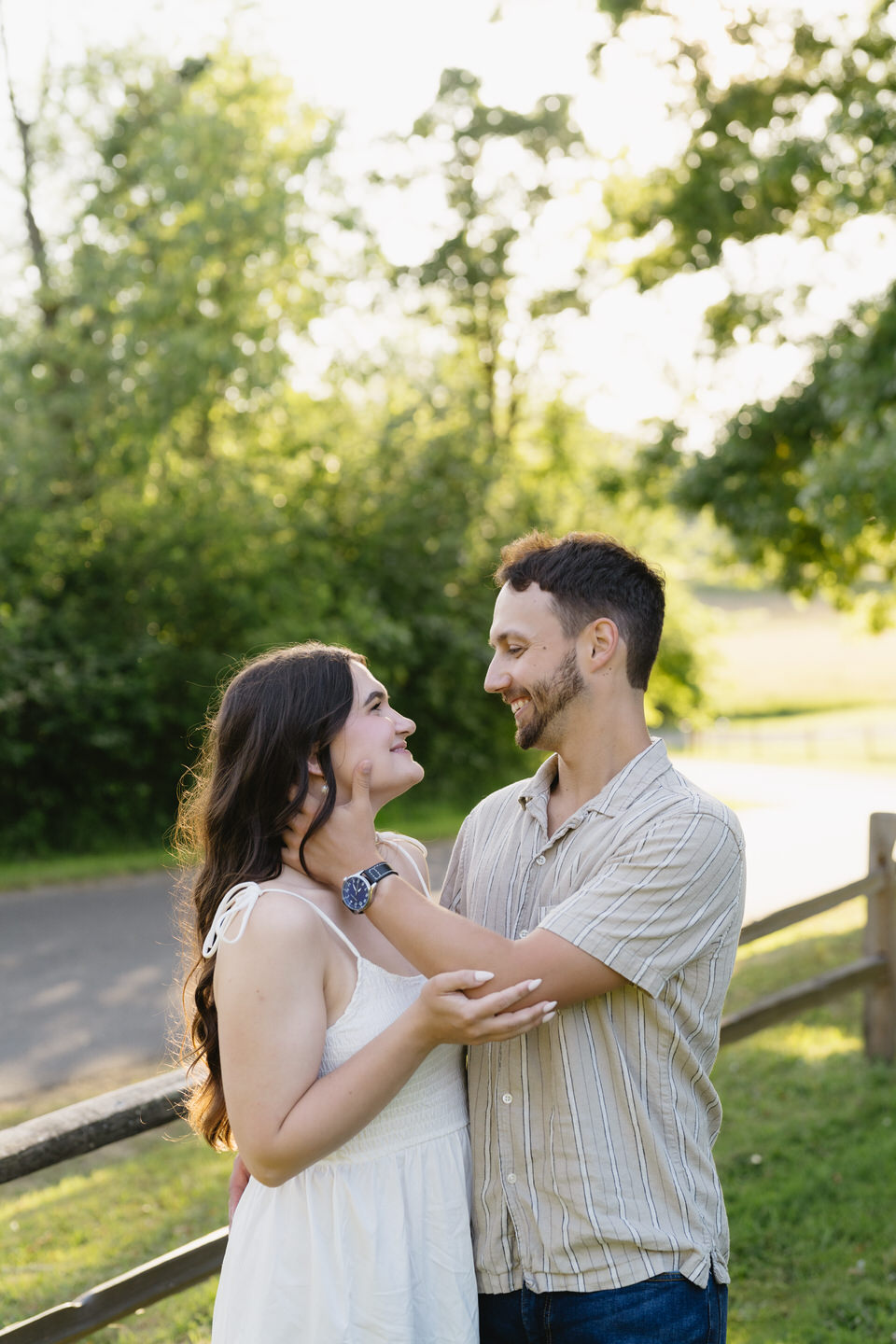 Man and woman look lovingly at one another among the greenery on Sauvie Island.