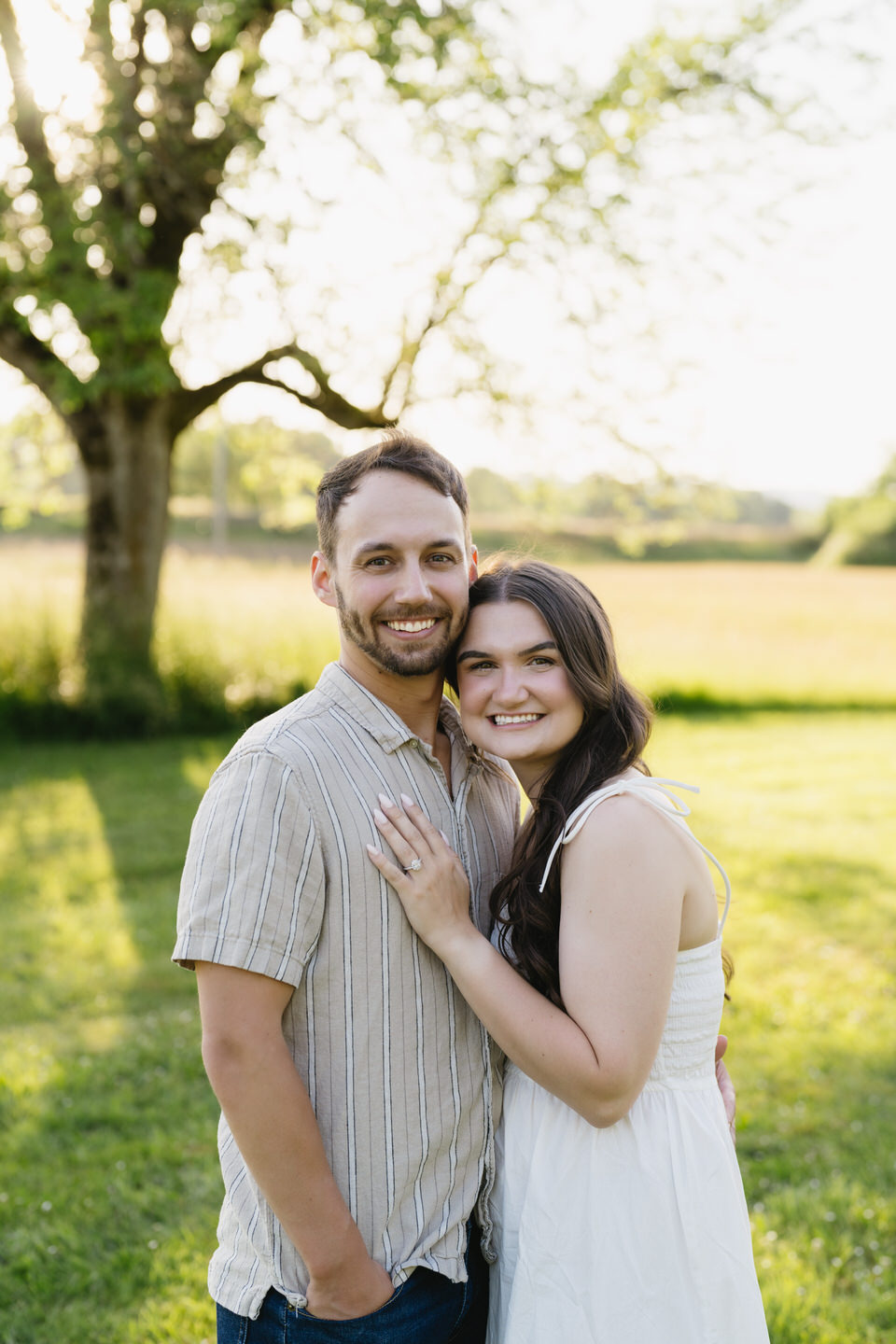 Golden hour light highlights the couple during their summer engagement photo shoot.