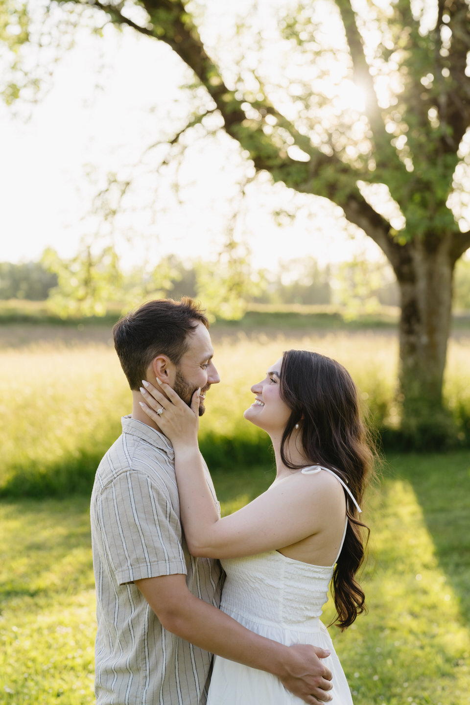 Bride-to-be holds her hand up to show her engagement ring.