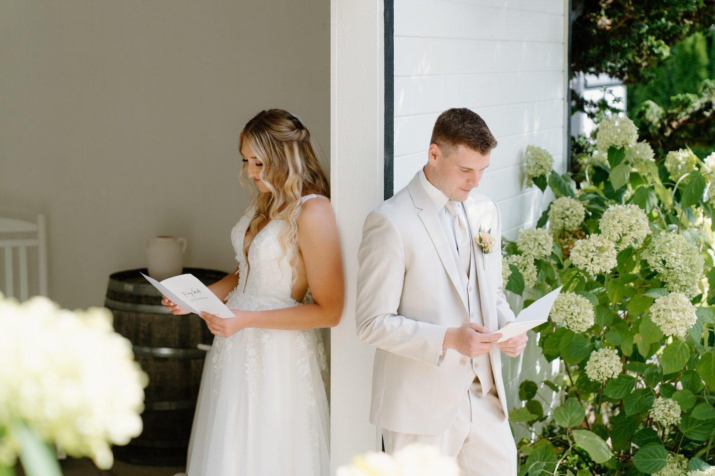 Bride and groom reading letters to each other during a private first touch before the ceremony at Cape Horn Estate.