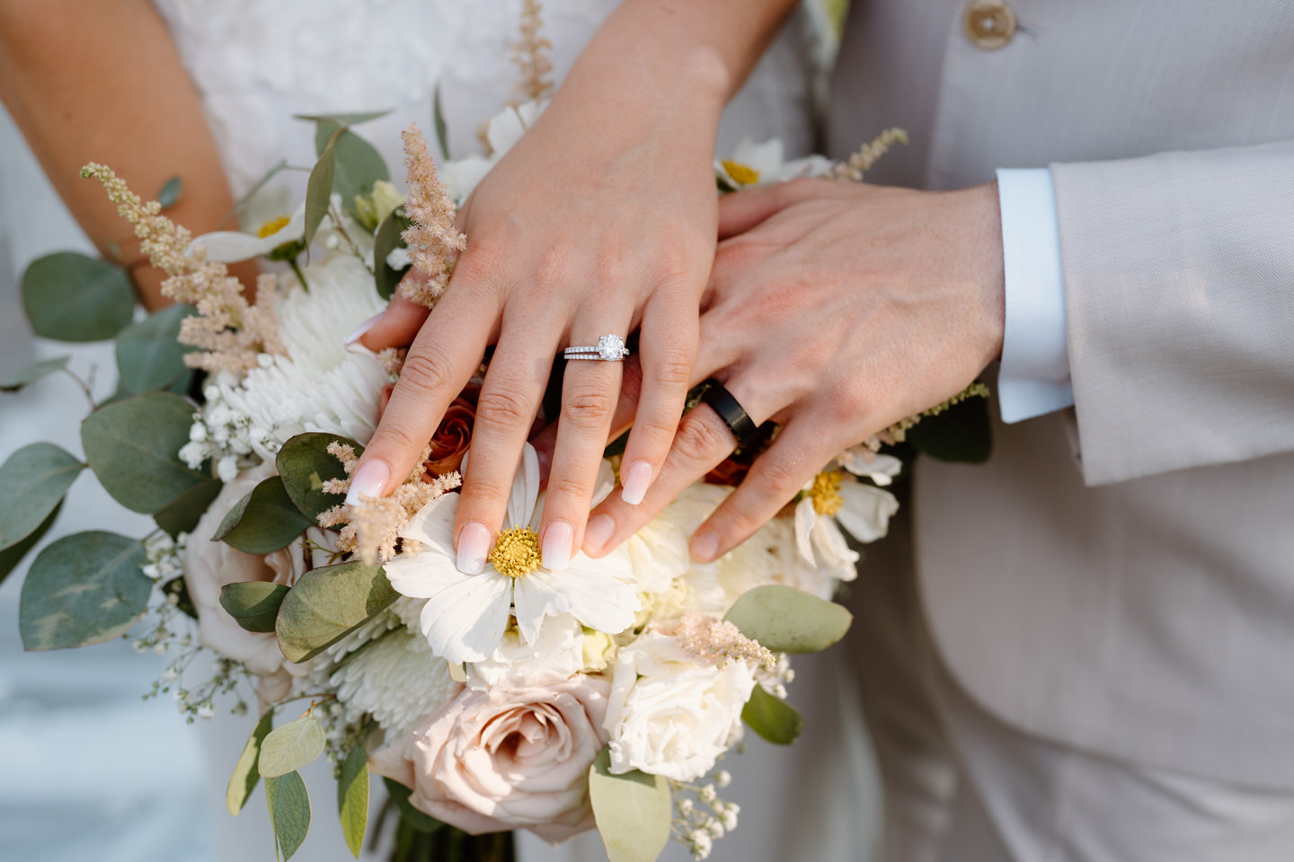 Both wedding rings over the bridal bouquet.