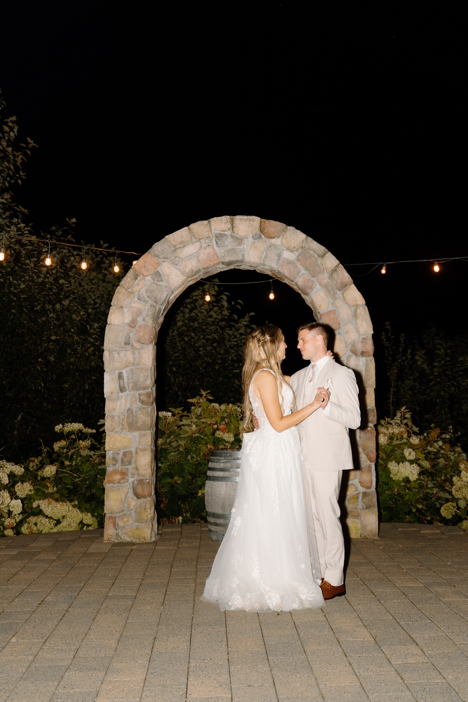 Couple shares their last dance of the night under the string lights at Cape Horn Estate.