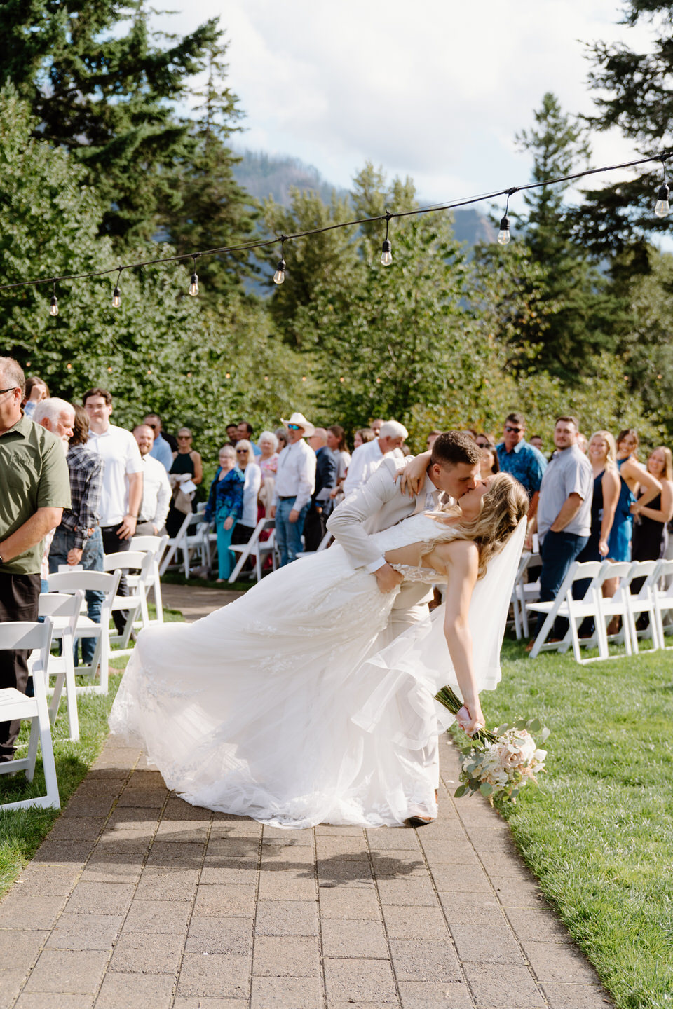 Bride and groom kiss as they walk back down the aisle.