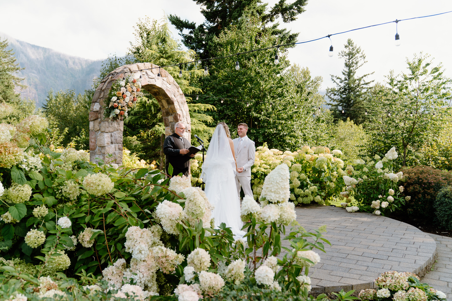 Wedding ceremony at Cape Horn Estate in a garden of hydrangeas.