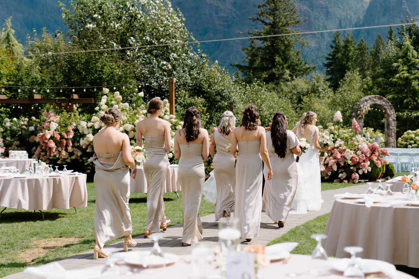 The bride and bridesmaids walk through the reception space at Cape Horn Estate.