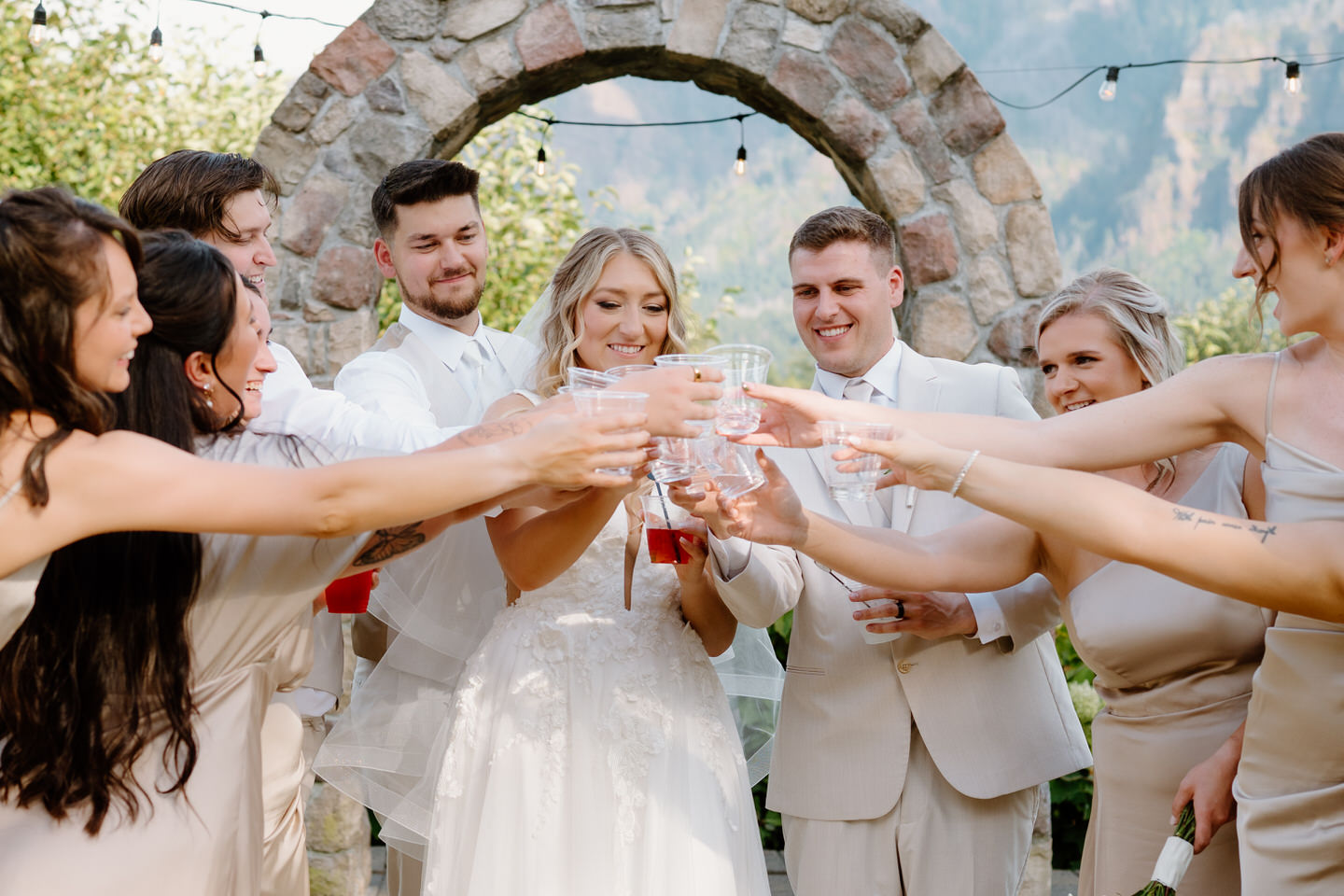 Wedding party has a cheers together, taking a shot once the ceremony ends.