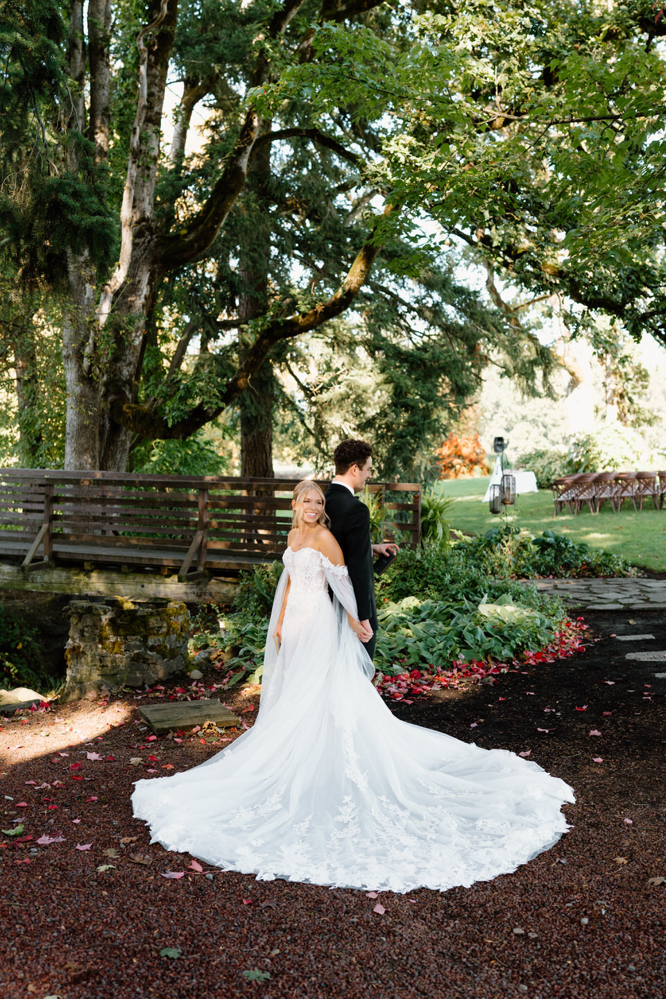 Bride and groom standing back-to-back, having a "first touch" before their wedding at Postlewaits.