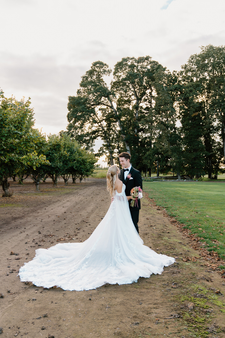 Wedding dress with a large train displayed on the property of Postlewaits.