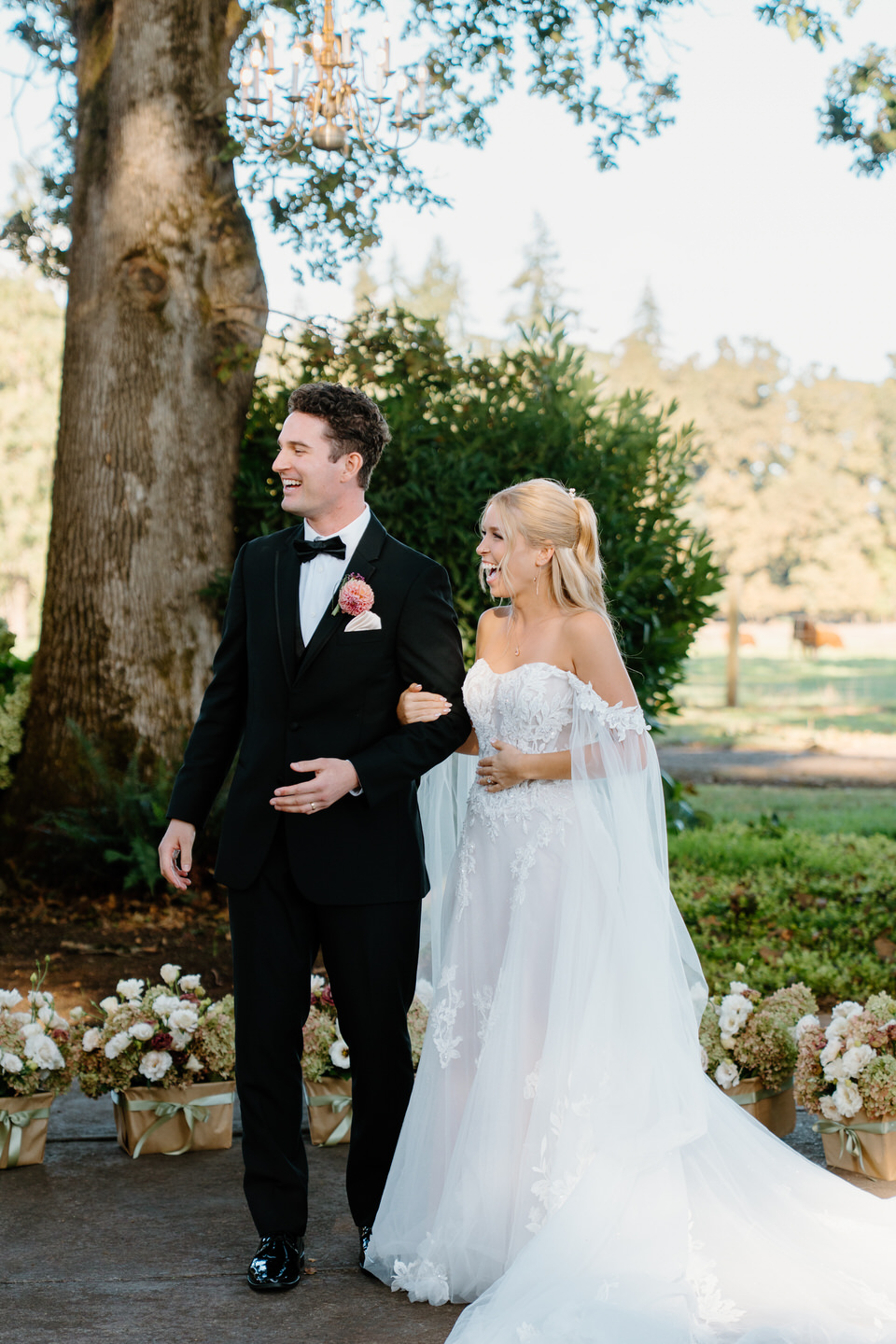 Bride and groom laugh during their wedding ceremony.