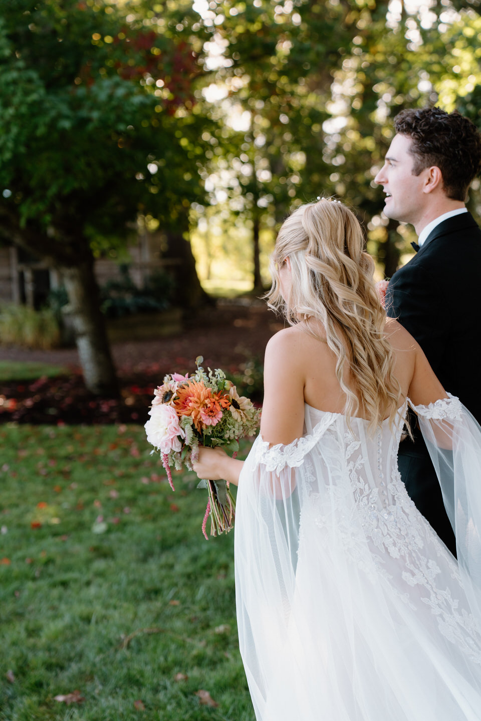 Bride and groom wistfully walking away after their wedding ceremony at Postlewait's.
