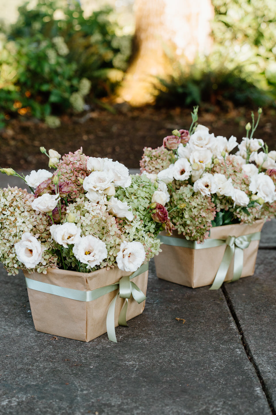 Ceremony flower arrangements in baskets on the ground.