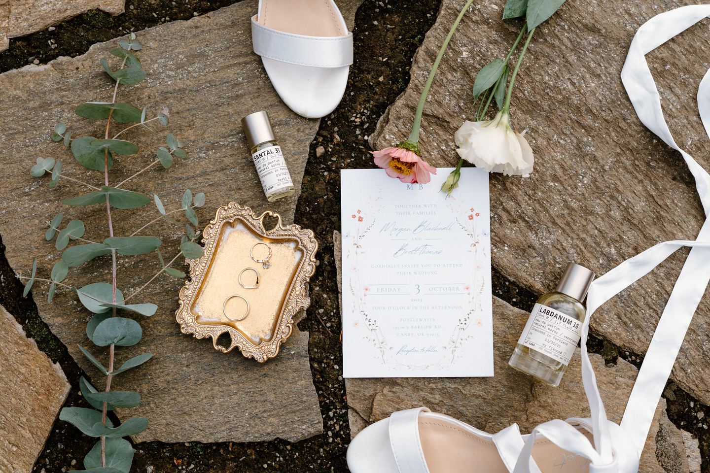 Wedding details displayed on the stone walkway before the wedding at Postlewaits.