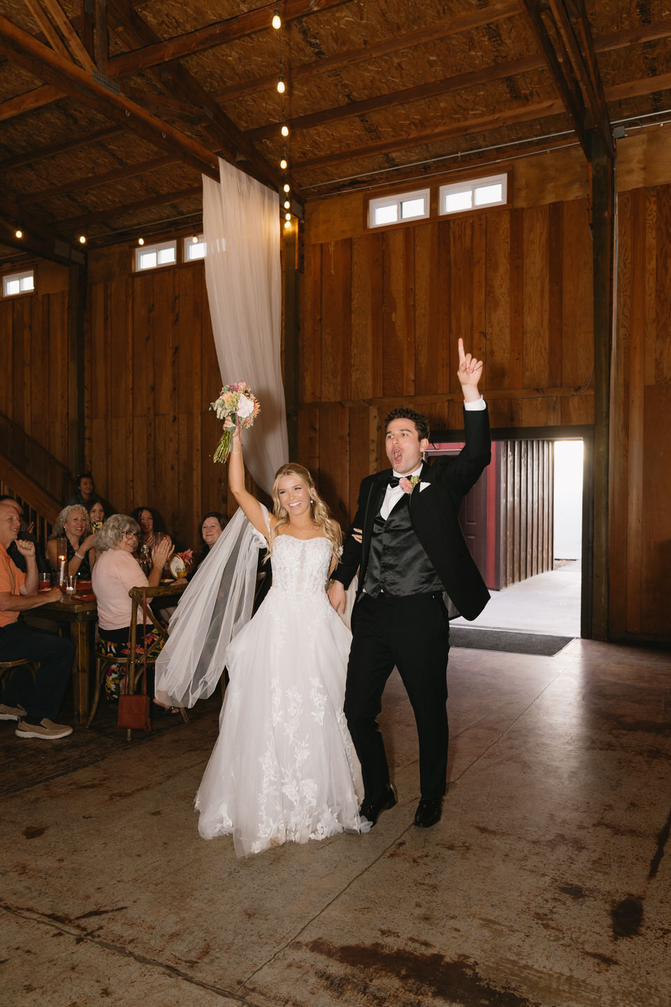 Couple makes their grand entrance into their wedding reception.