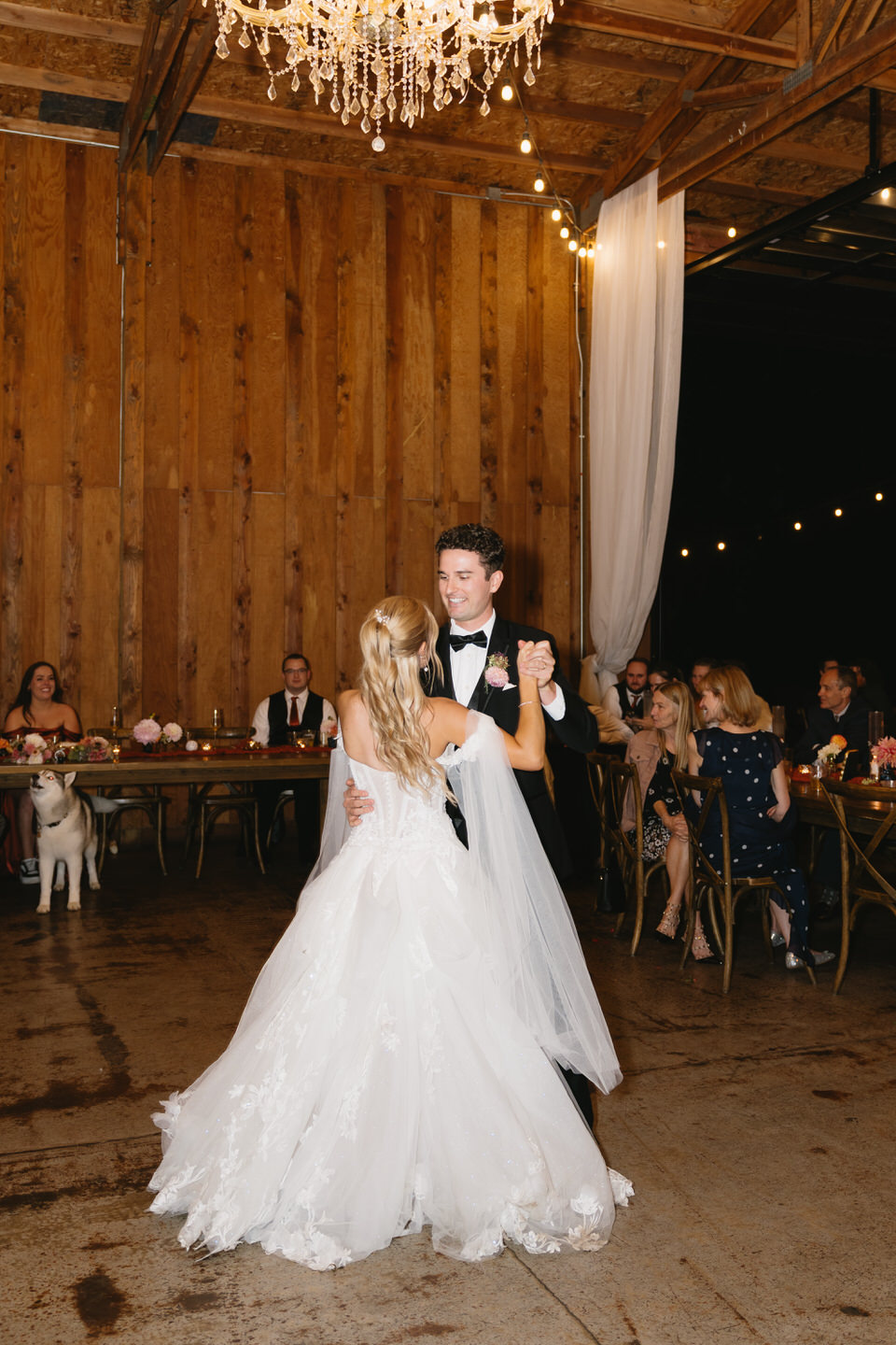 Couple shares their first dance in the indoor space at Postlewaits.