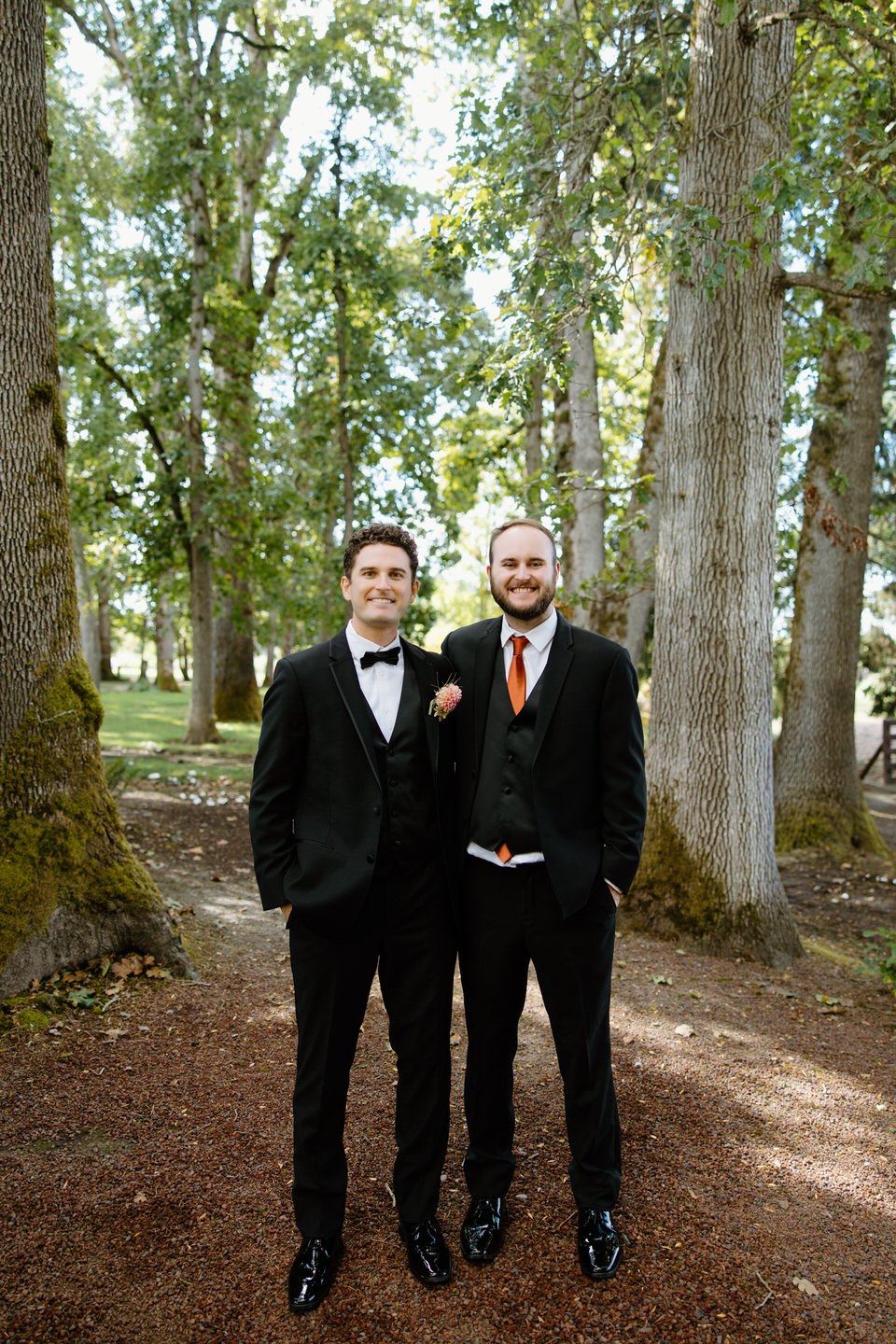 Groom and best man pose among the oak trees in Canby, OR.