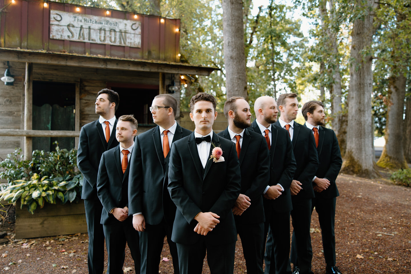Groomsmen in a v formation, the groom front and center.