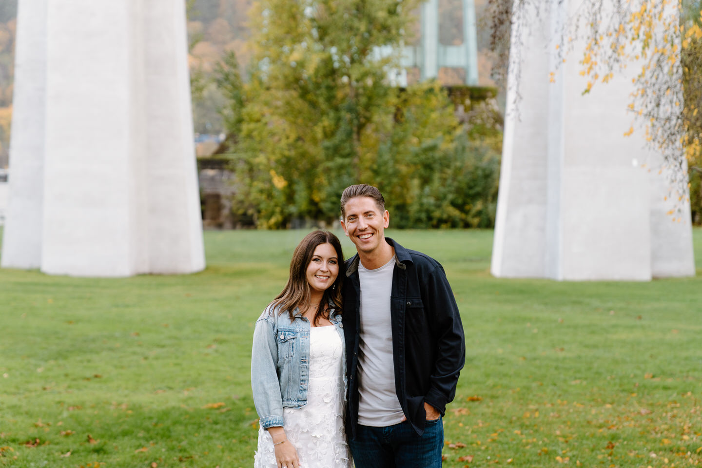 Couple stands beneath the St. Johns bridge in Portland.