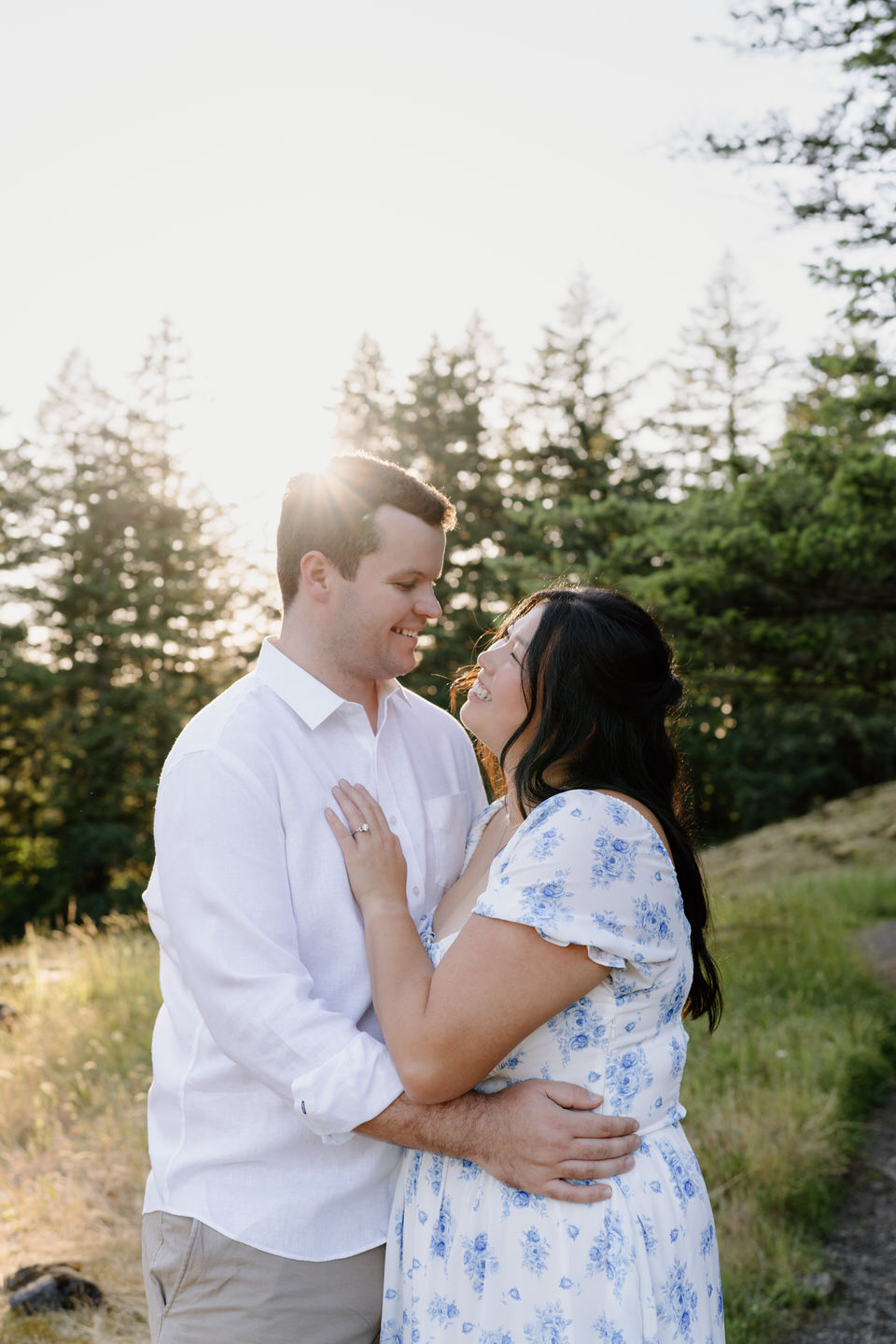 Detail shot of her hand on his shirt, showcasing connection and closeness in a softly lit outdoor setting.