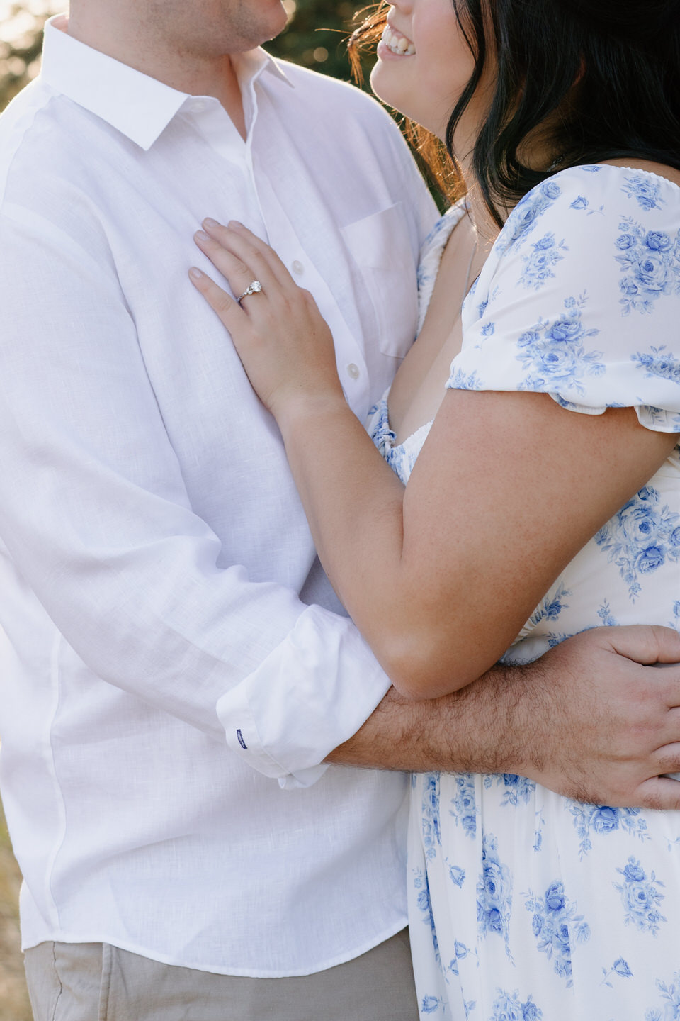 Close-up of the couple embracing, her hand resting on his chest as they share an intimate Vancouver, WA Engagement moment.