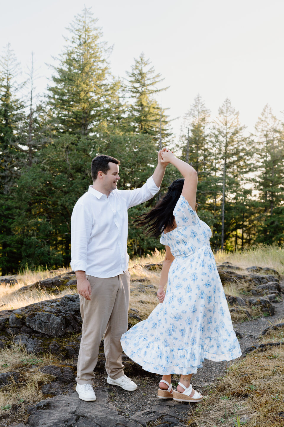 He spins her with a grin as she twirls, capturing movement and joy in this Vancouver, WA Engagement portrait.