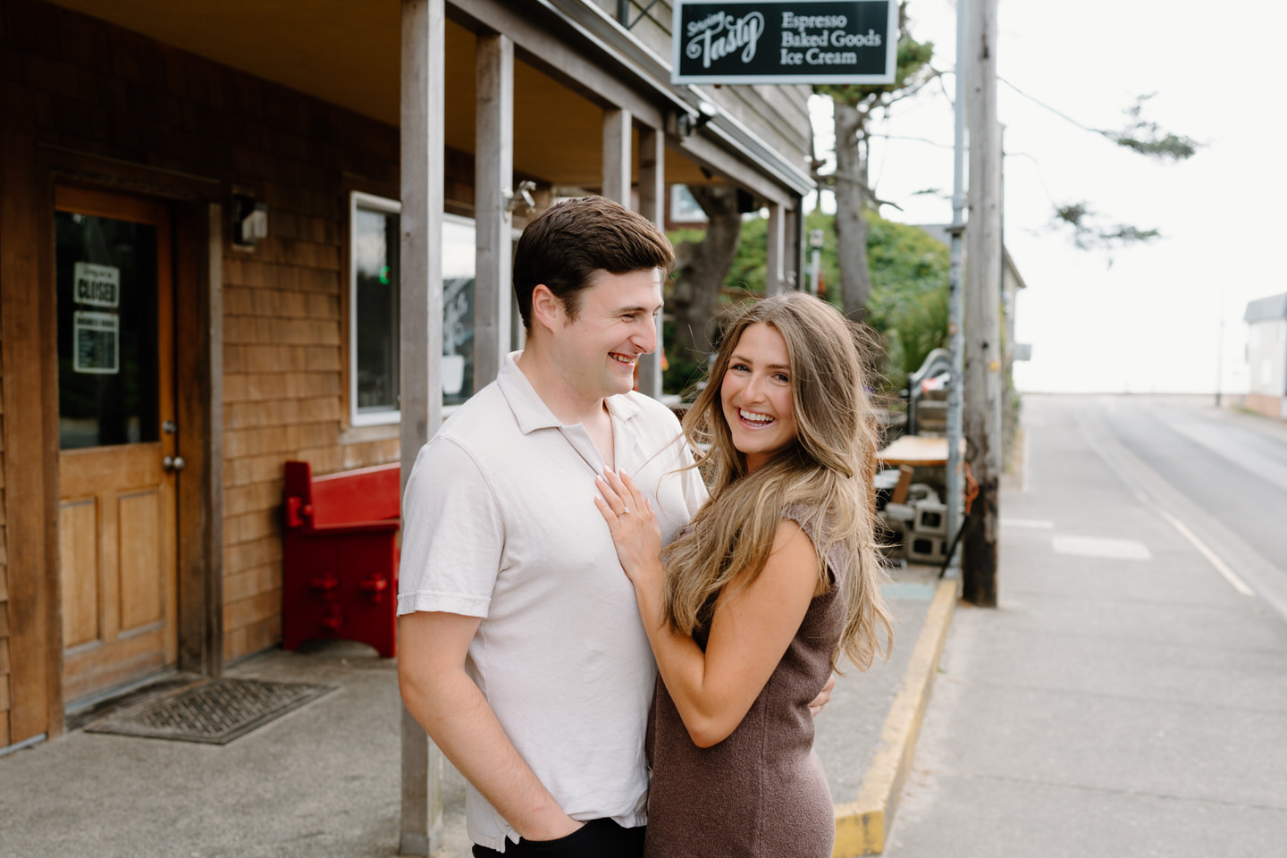 Couple posing in front of Manzanita Coffee Co, a significant place in their relationship.