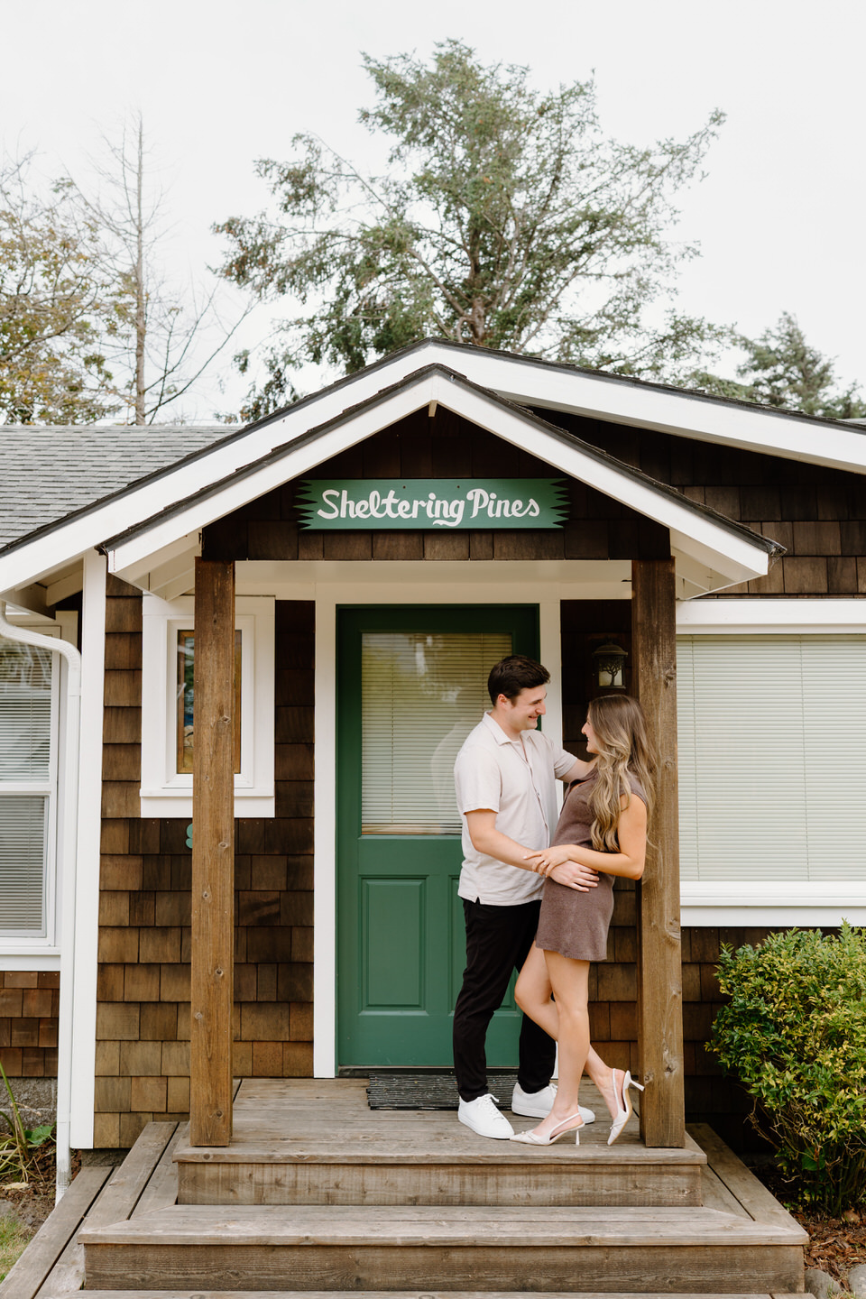Engaged couple in front of their family's beach house in Manzanita.
