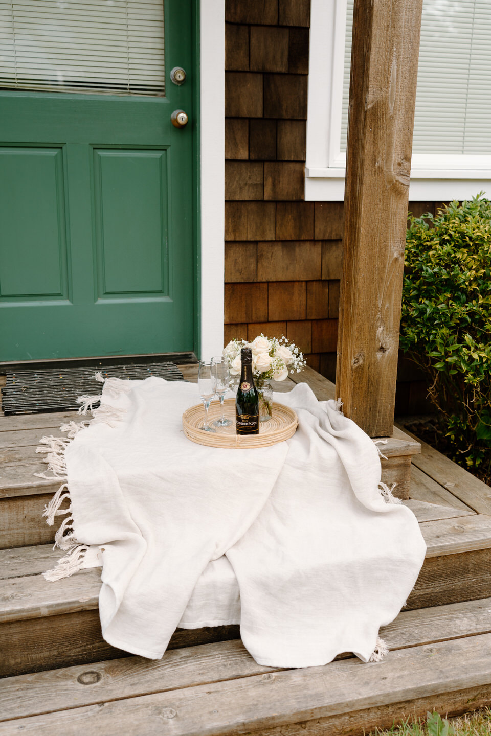Boho luxury picnic setup on the front porch of Oregon beach house.