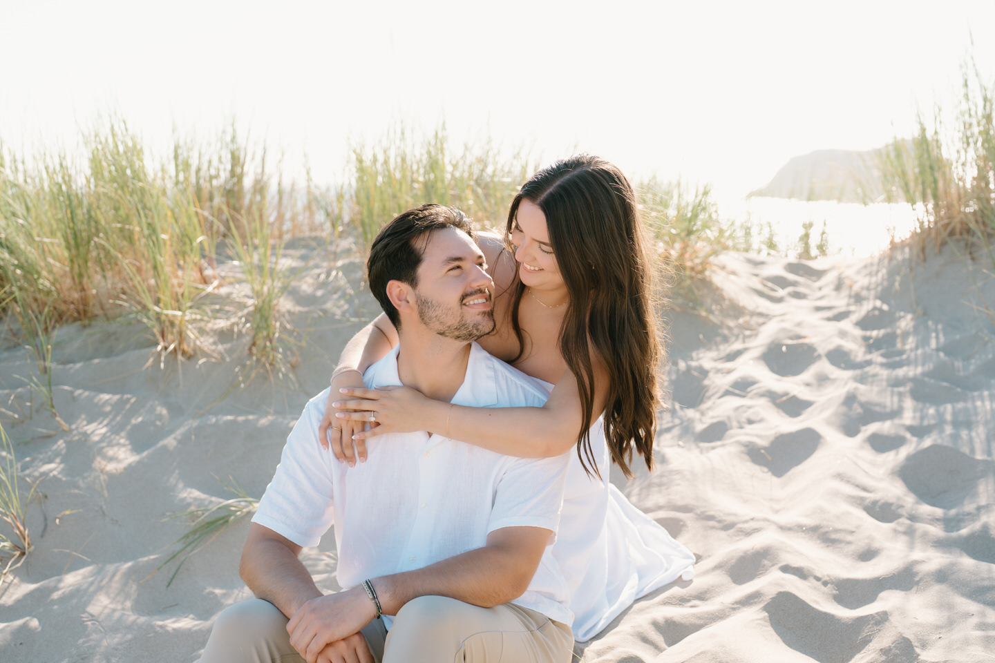 A warm glow surrounds couple during their engagement photos on the Oregon coast.