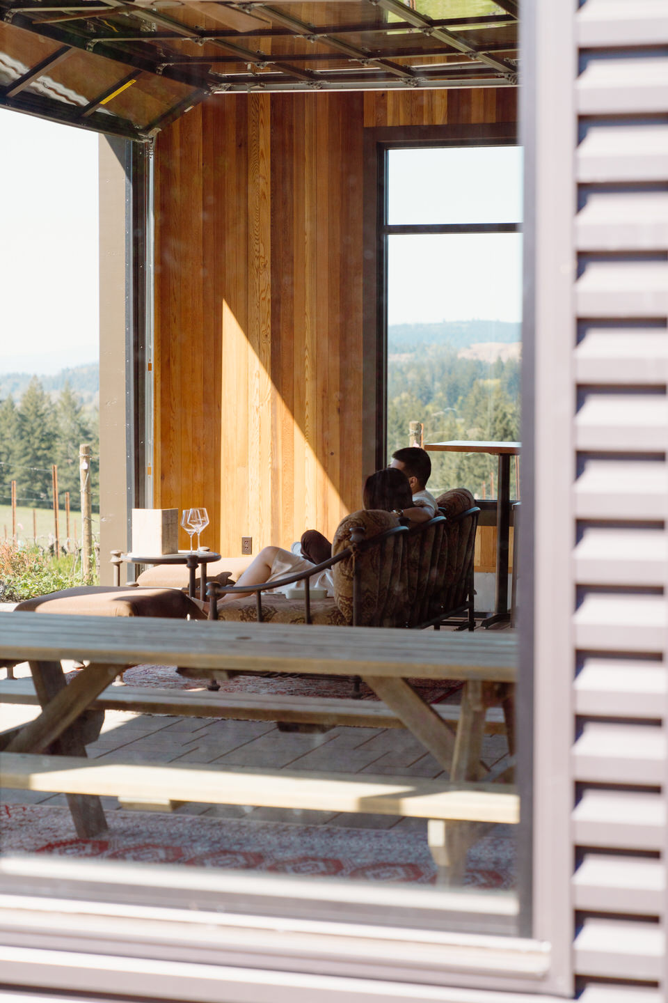 Modern winery exterior at Eminent Domaine set against Oregon vineyard landscape on a clear spring day.