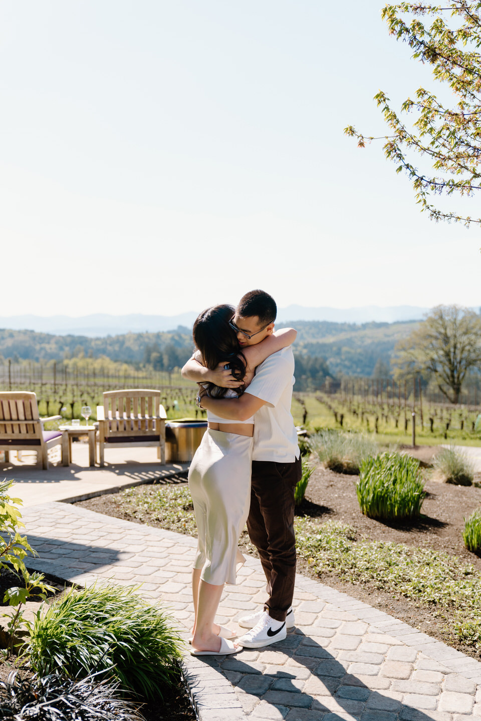 Couple hugs after proposal moment in Oregon's wine country.
